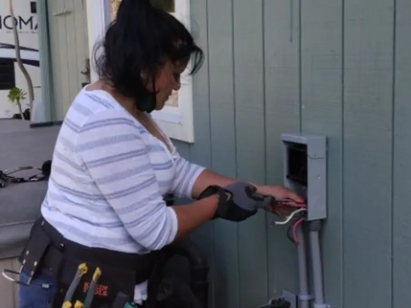Licensed electrician wiring an exterior subpanel in Bonita